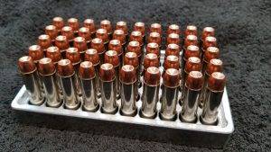 357 Magnum 158 grain Jacketed Hollow Point remanufactured pistol ammo sitting in an ammo tray nose up. Made in the USA by Ammo by Pistol Pete